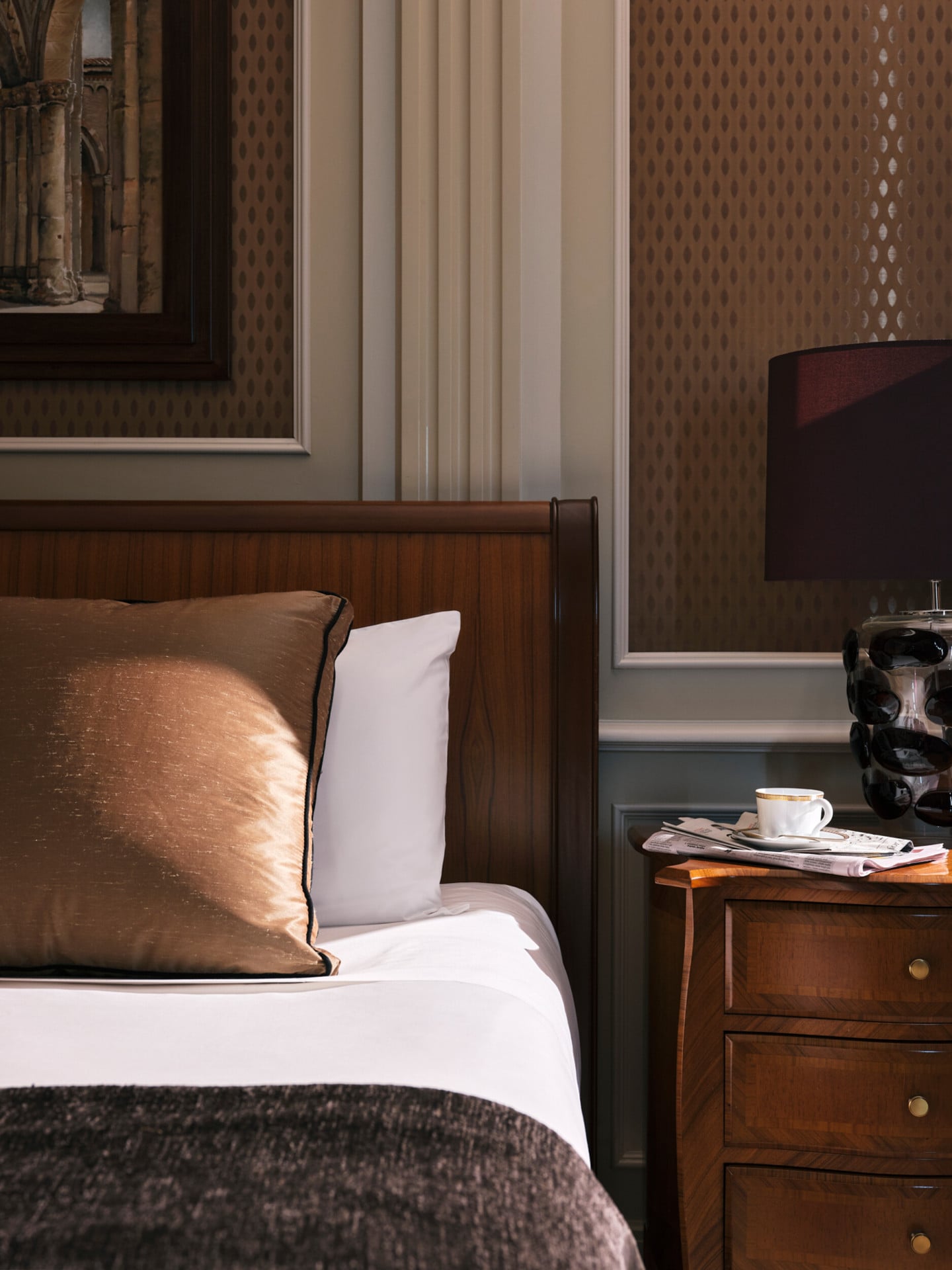 Detail shot of a Deluxe room with bed and bedside table