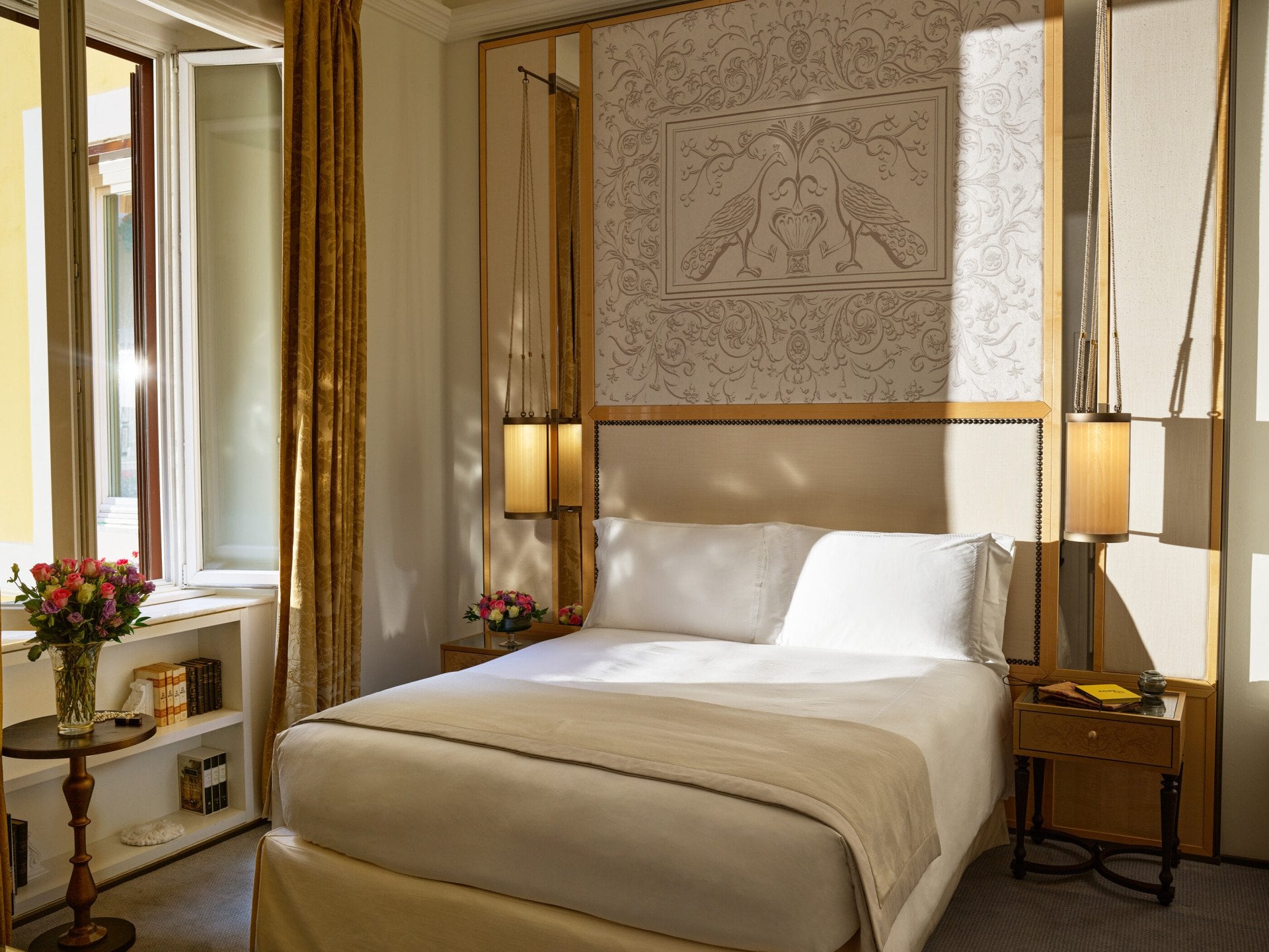 Bedroom of classic room with twin beds, headboard with peacocks illustration and window, at Hotel Eden, Rome