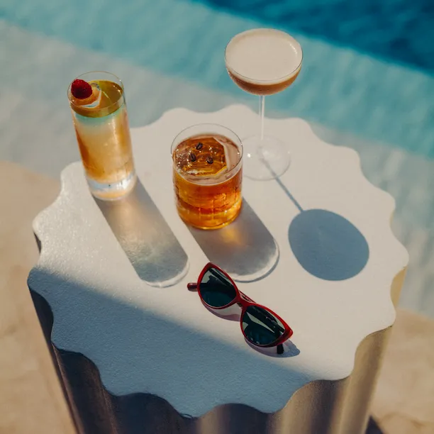 A selection of drinks in High Society's table by the pool