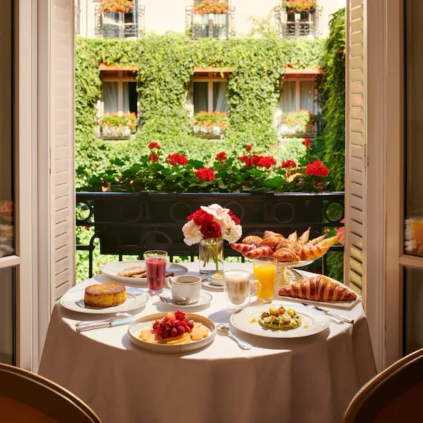 Images of the brunch in room showing pastries and fresh fruits with a view on La Cour Jardin