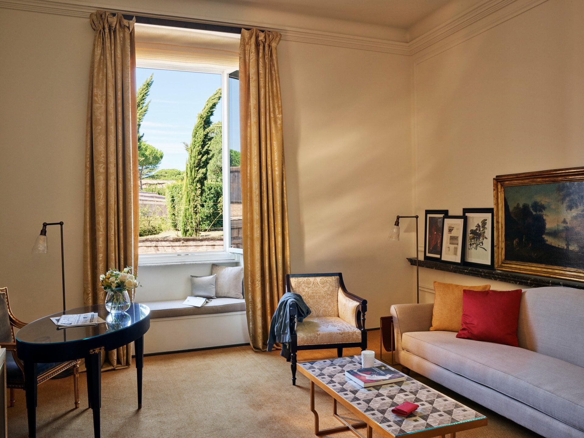 Living Room of Classic suite with open window, couch, armchair and desk at Hotel Eden, Rome