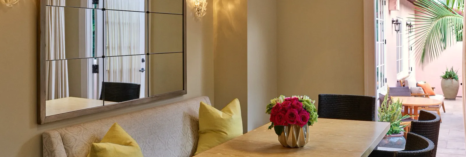 Private dining area with table and chairs inside the bell suite at Hotel Bel-Air, leads to patio