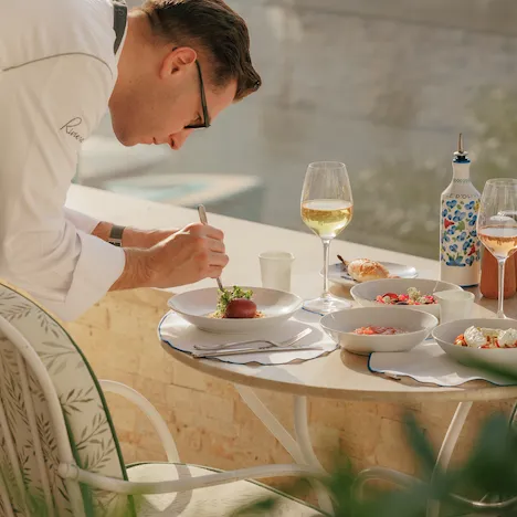 Riviera's chef adding the final details in a dish