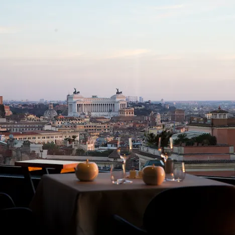 Table by the window at La Terrazza restaurant with view of Altare della Patria, Hotel Eden, Rome