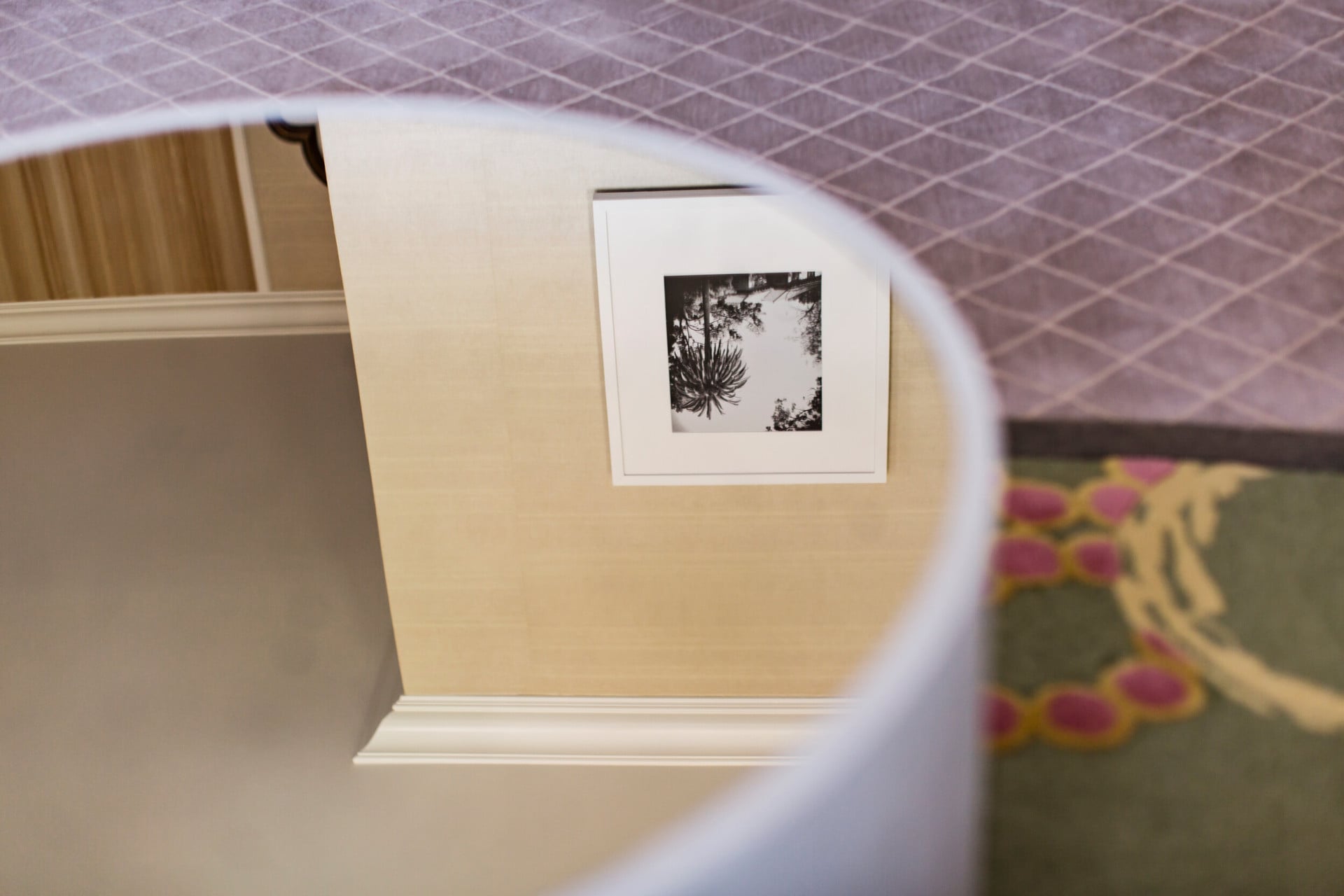 Mirrored side table and close up of colorful patterned rug detail in a Beverly Hills Hotel Suite