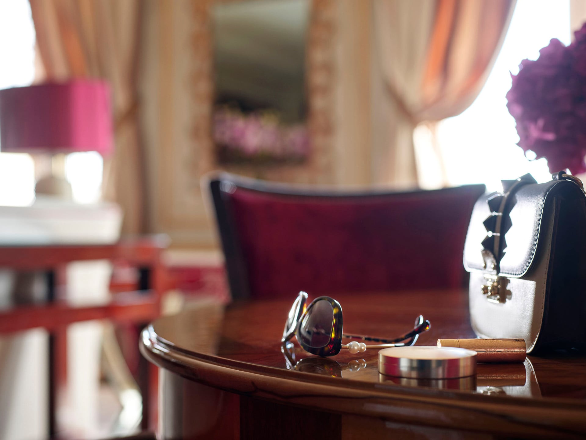 Imperial Executive Suite Detail with sunglasses, make up essentials and a pale brown handbag