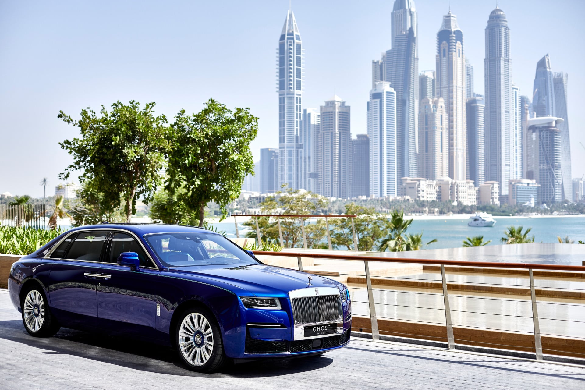 Blue rolls royce car with Dubai skyline background