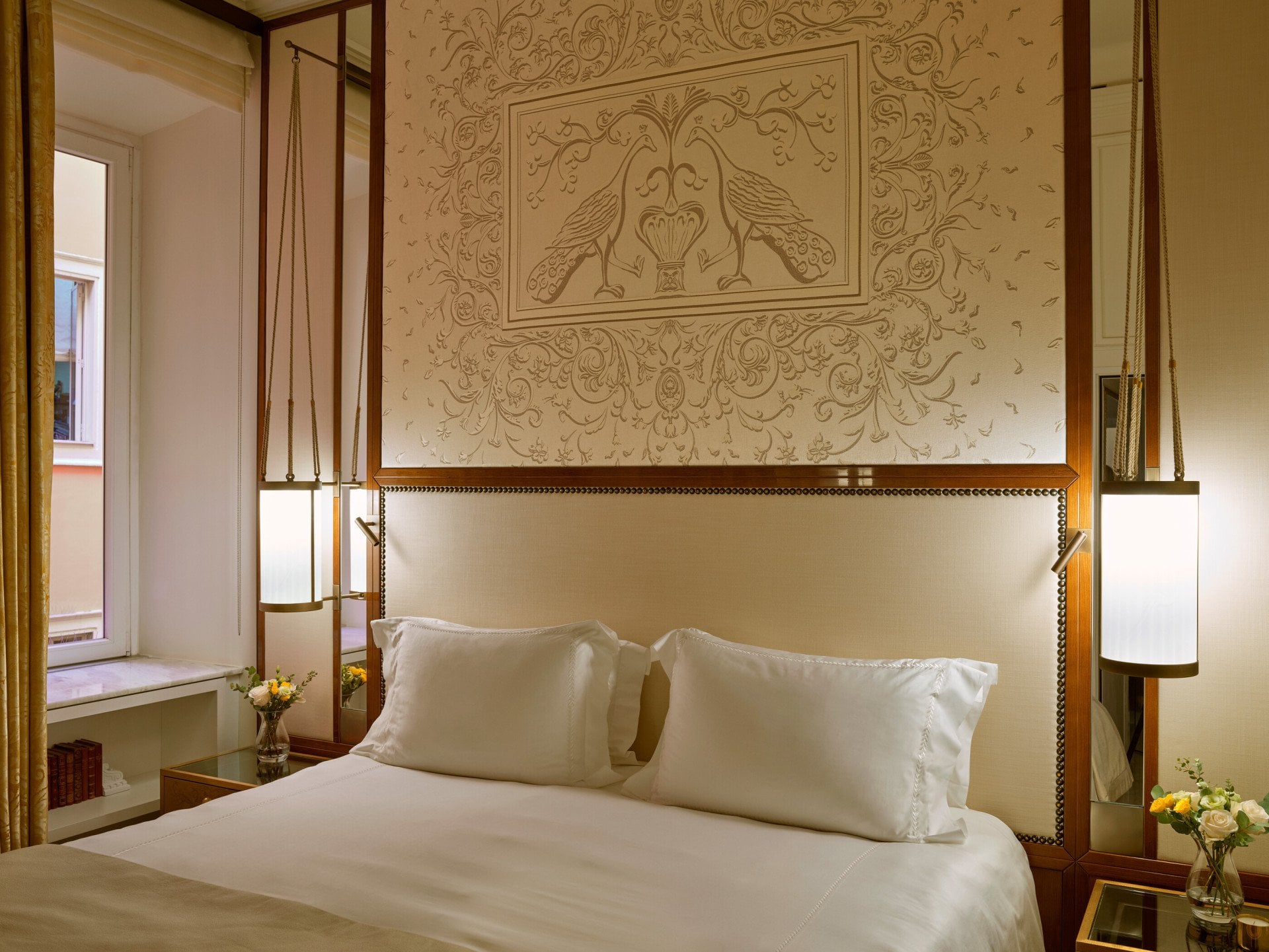 Bedroom of Classic suite and headboard with peacocks decoration at Hotel Eden, Rome