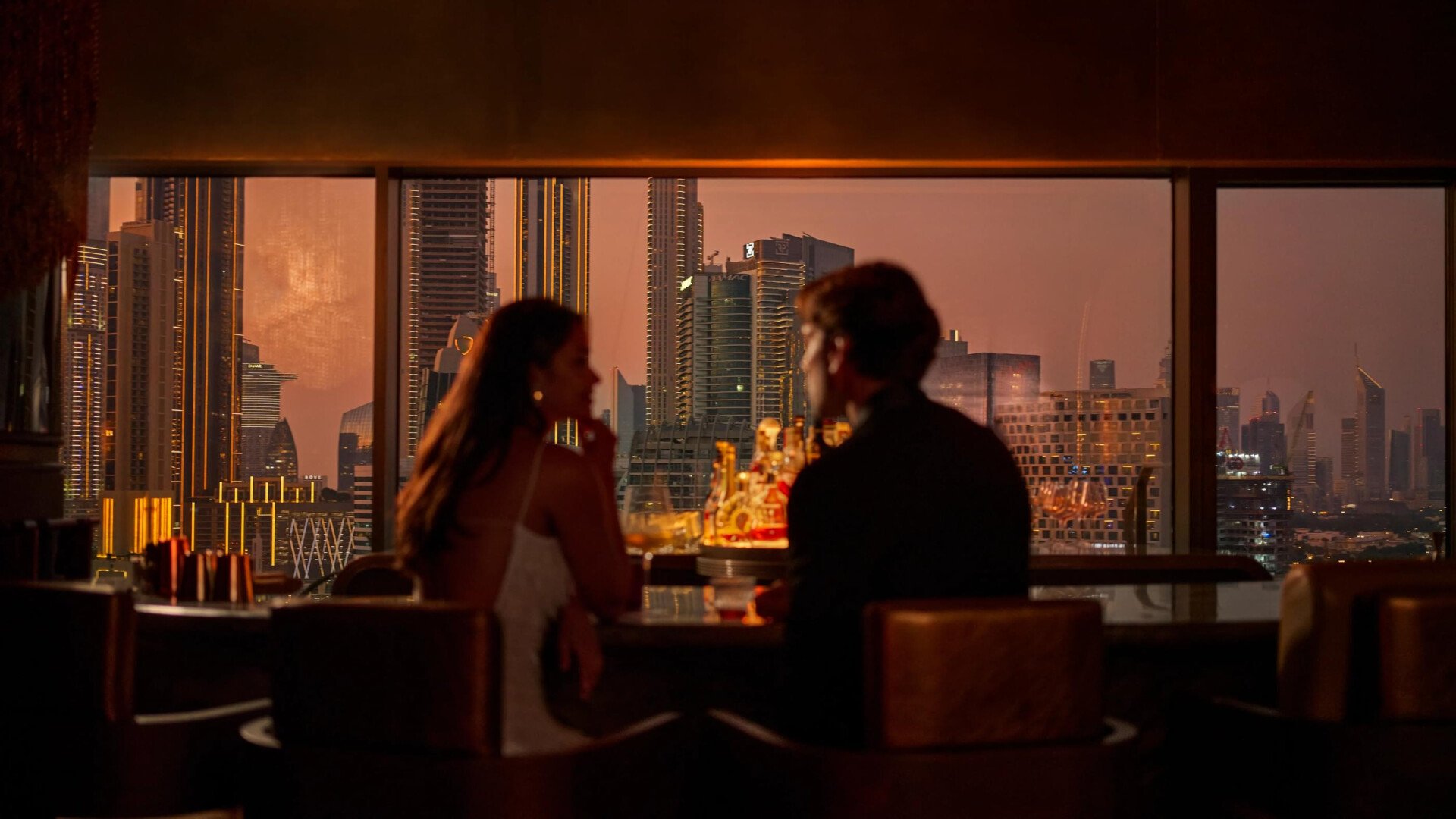 A couple sitting in the bar of Txakolina