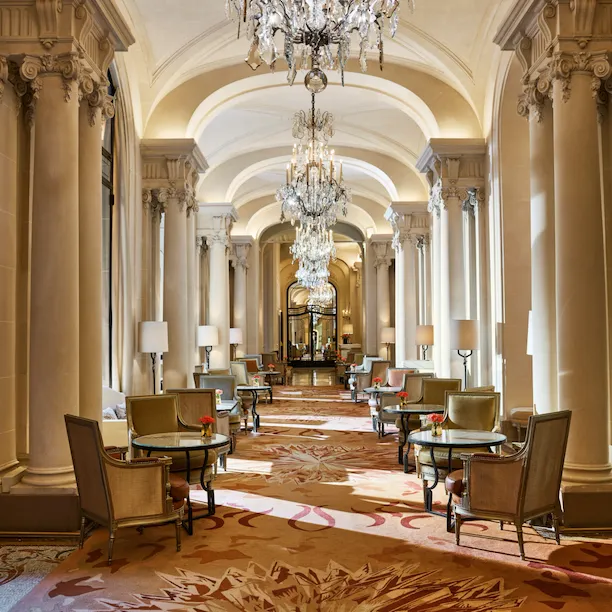 La Galerie dining room corridor with its chandeliers and set up tables, at Hotel Plaza Athénée, Paris