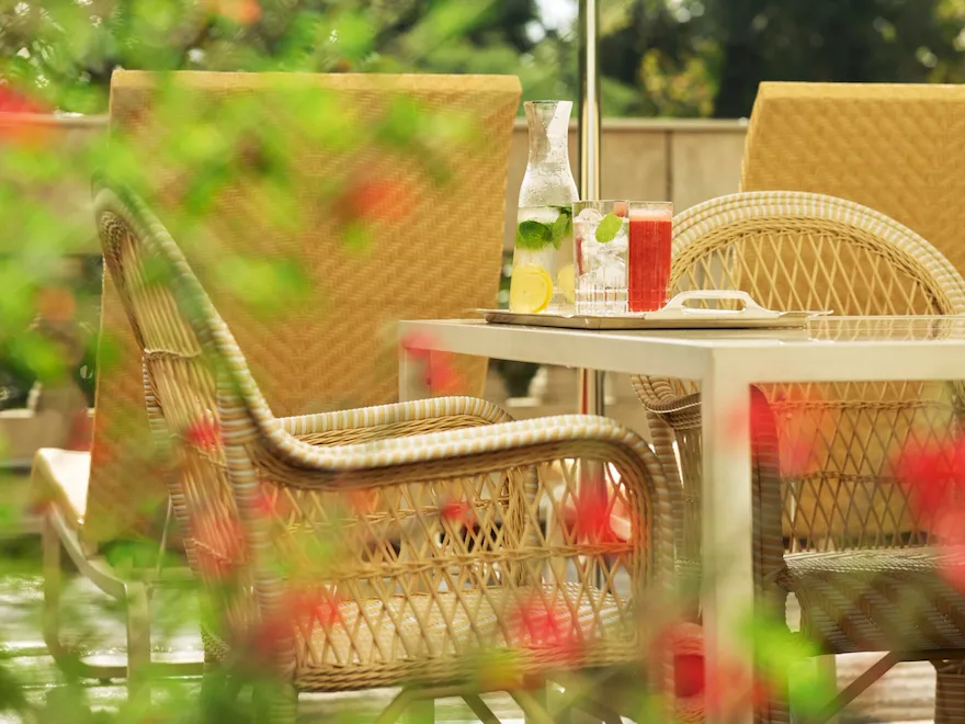 View of Principe Suite terrace with details of flowers and a table with chair