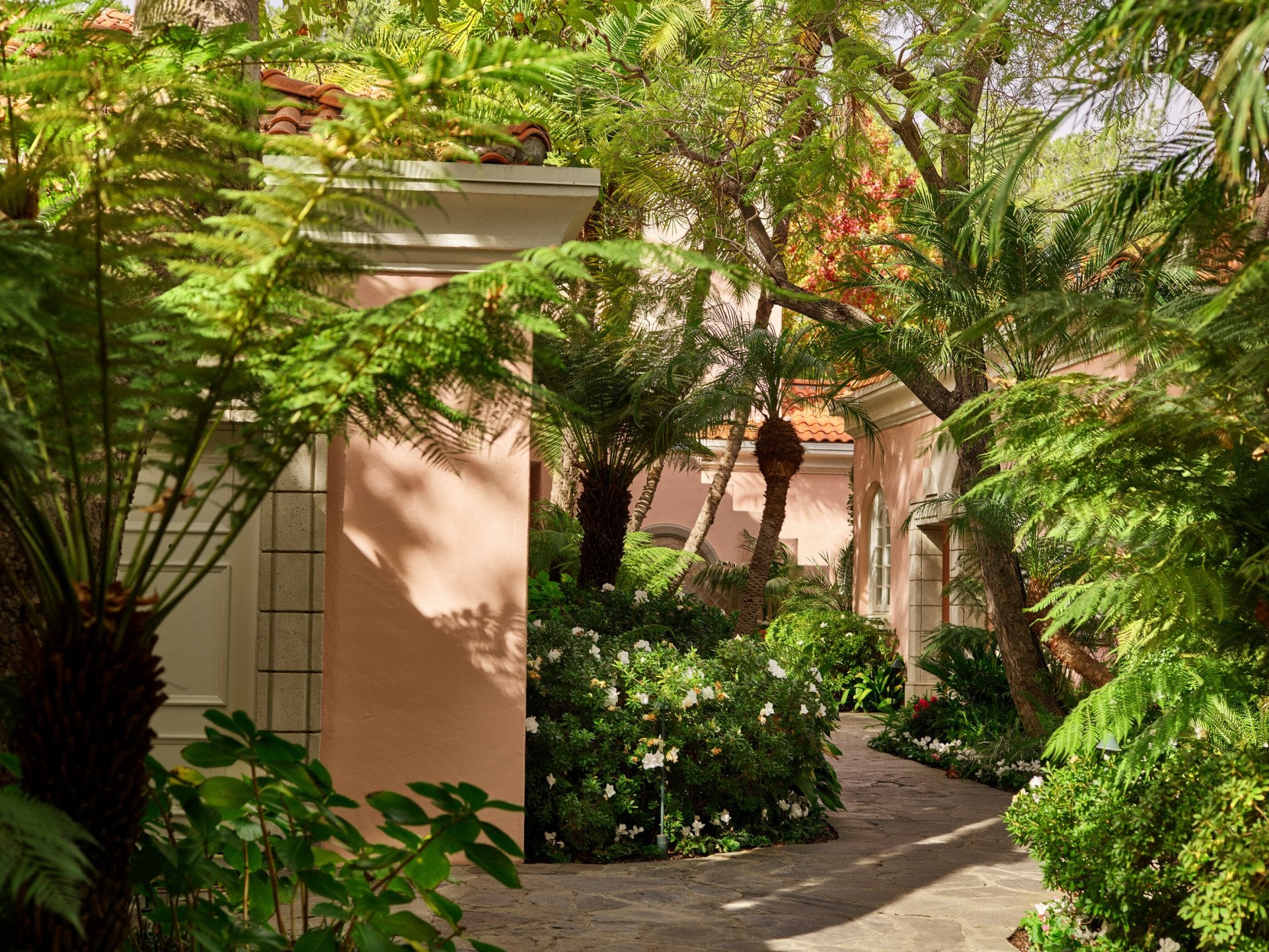 Garden pathways lead to rooms, suites and fountains