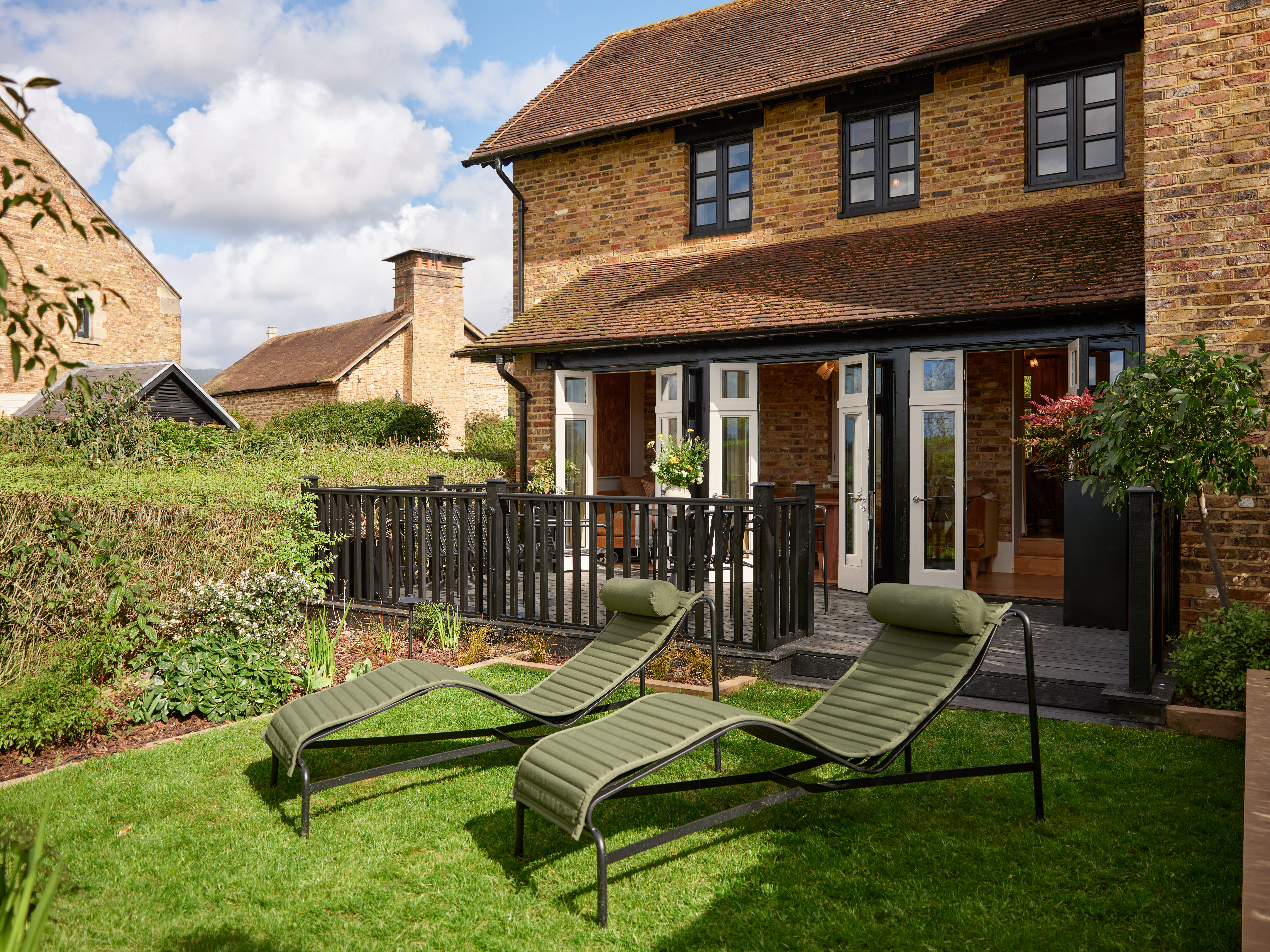 Private garden with sun loungers at the Gardeners East suite, Coworth Park