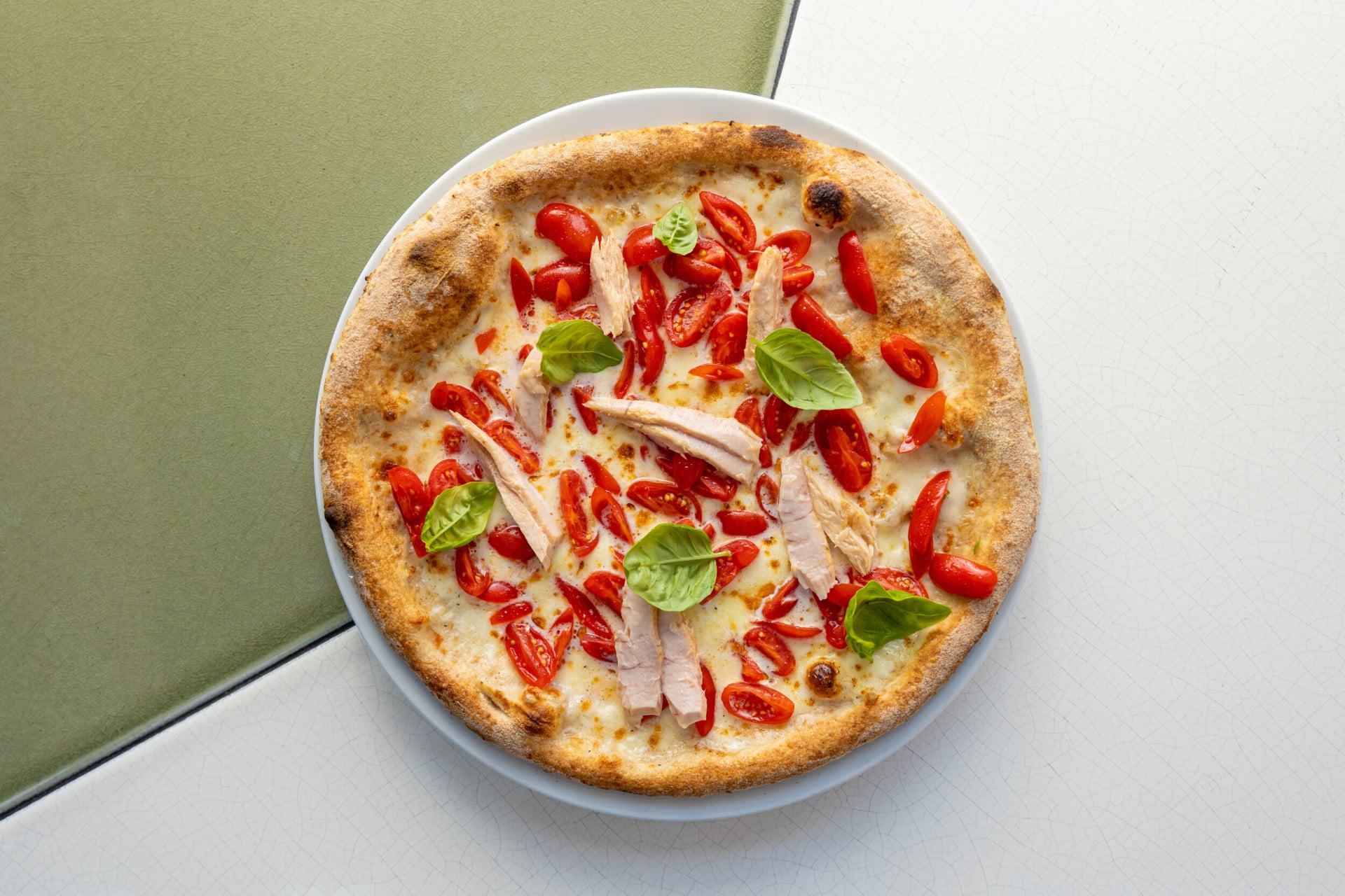 Pizza seasoned with cherry tomatoes, mozzarella of buffalo, tuna, and basil at Il Giardino Ristorante, Hotel Eden in Rome