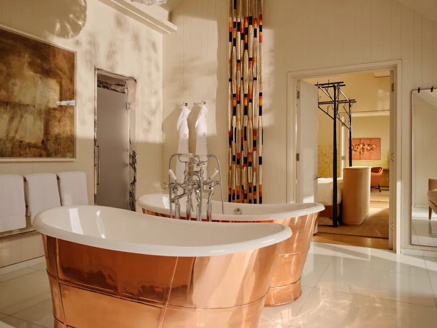 Freestanding copper bathtub in the Fairway Stable Premium Suite at Coworth Park