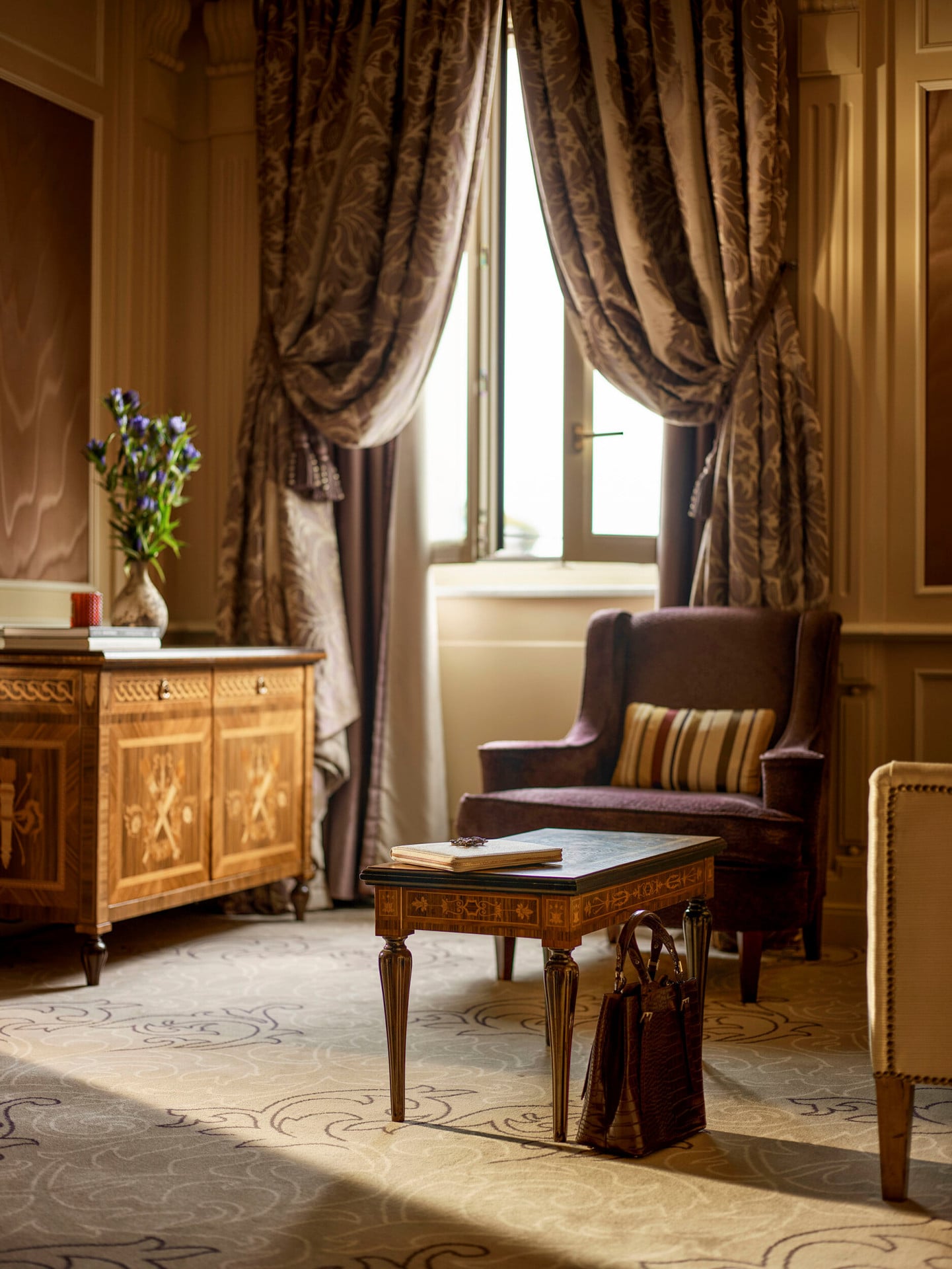 Ambassador Suite Living Room Detail of a brown bag on the floor matching the colours of the pieces of furniture