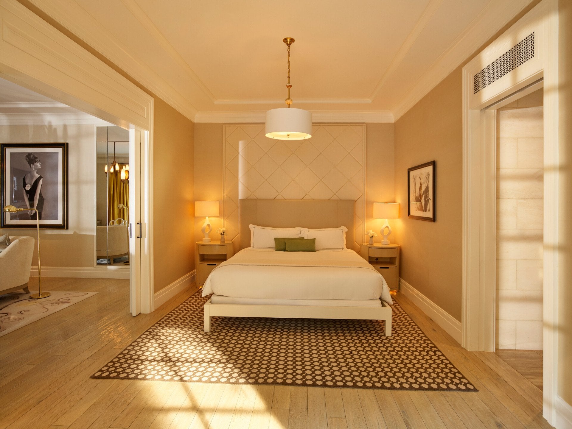View of the light and spacious bedroom bed with accompanying nightstands and white table lamps in the legendary Grace Kelly signature suite at Hotel Bel-Air. 