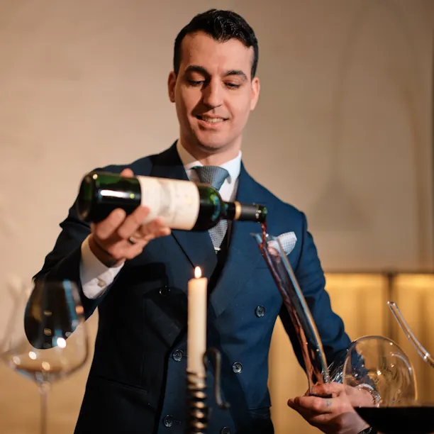 Sommelier decanting red wine at Woven by Adam Smith, Coworth Park