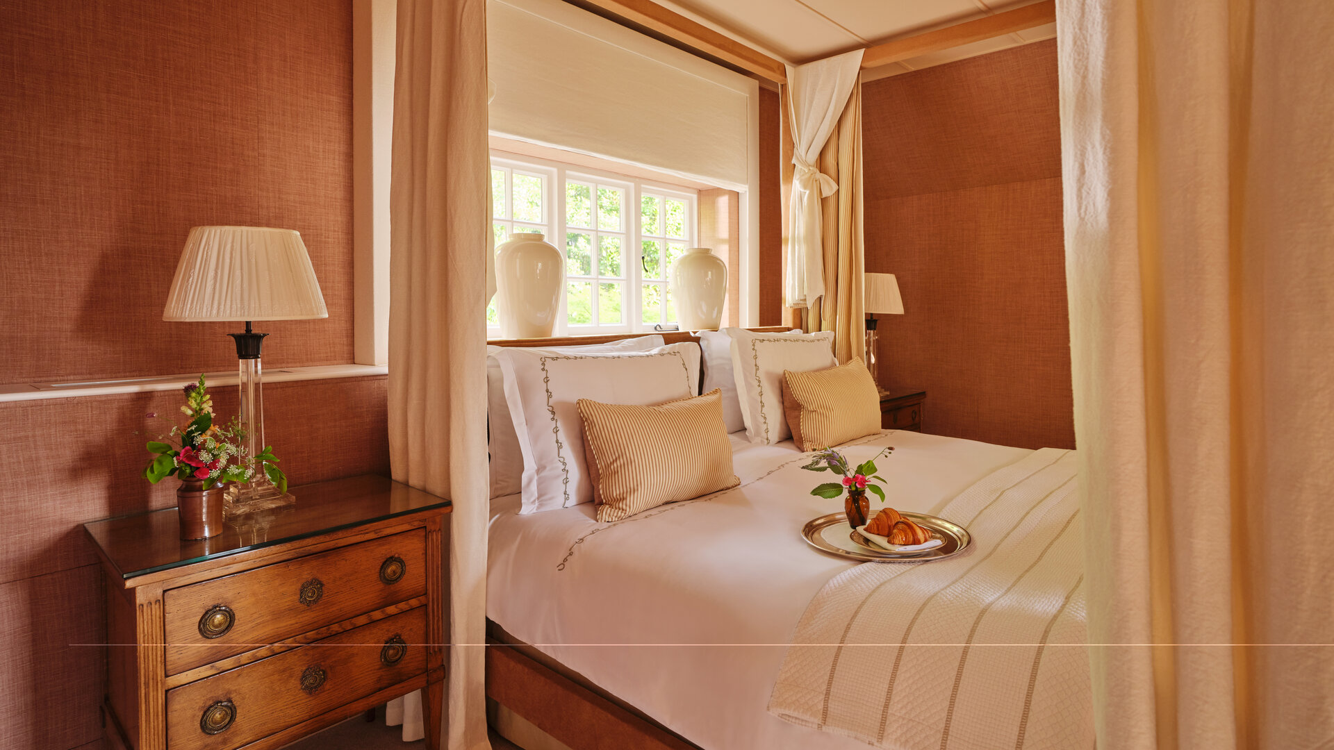 Master bedroom in the Dower House signature suite at Coworth Park, Ascot
