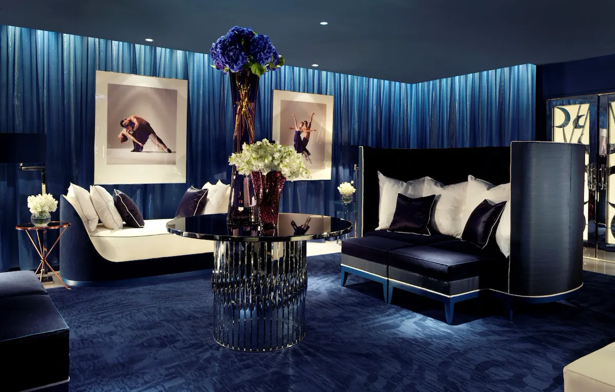 A welcoming, comfortable low-lit room in deep blue tones