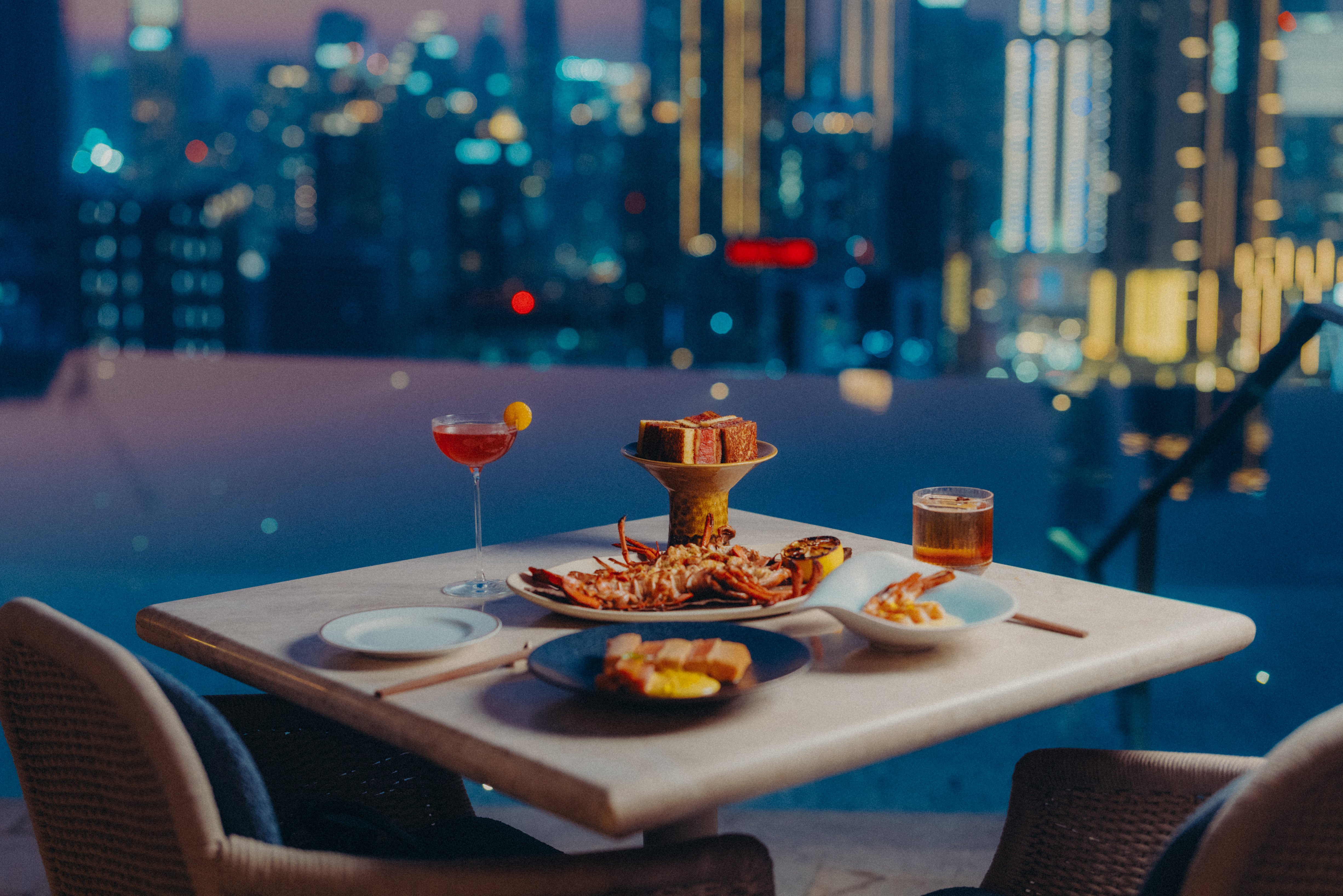 High Society's Japanese inspired dishes on a table in front of the pool