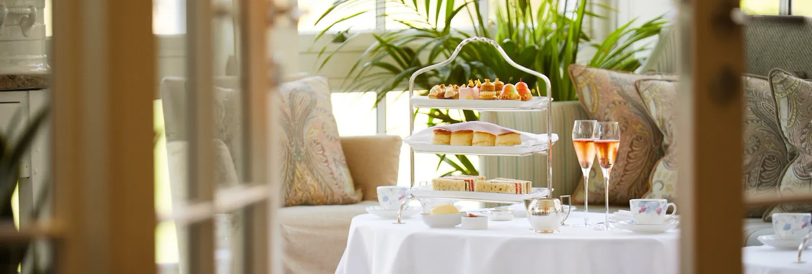 Coworth Park-Drawing Room conservatory afternoon tea infront with rose champagne