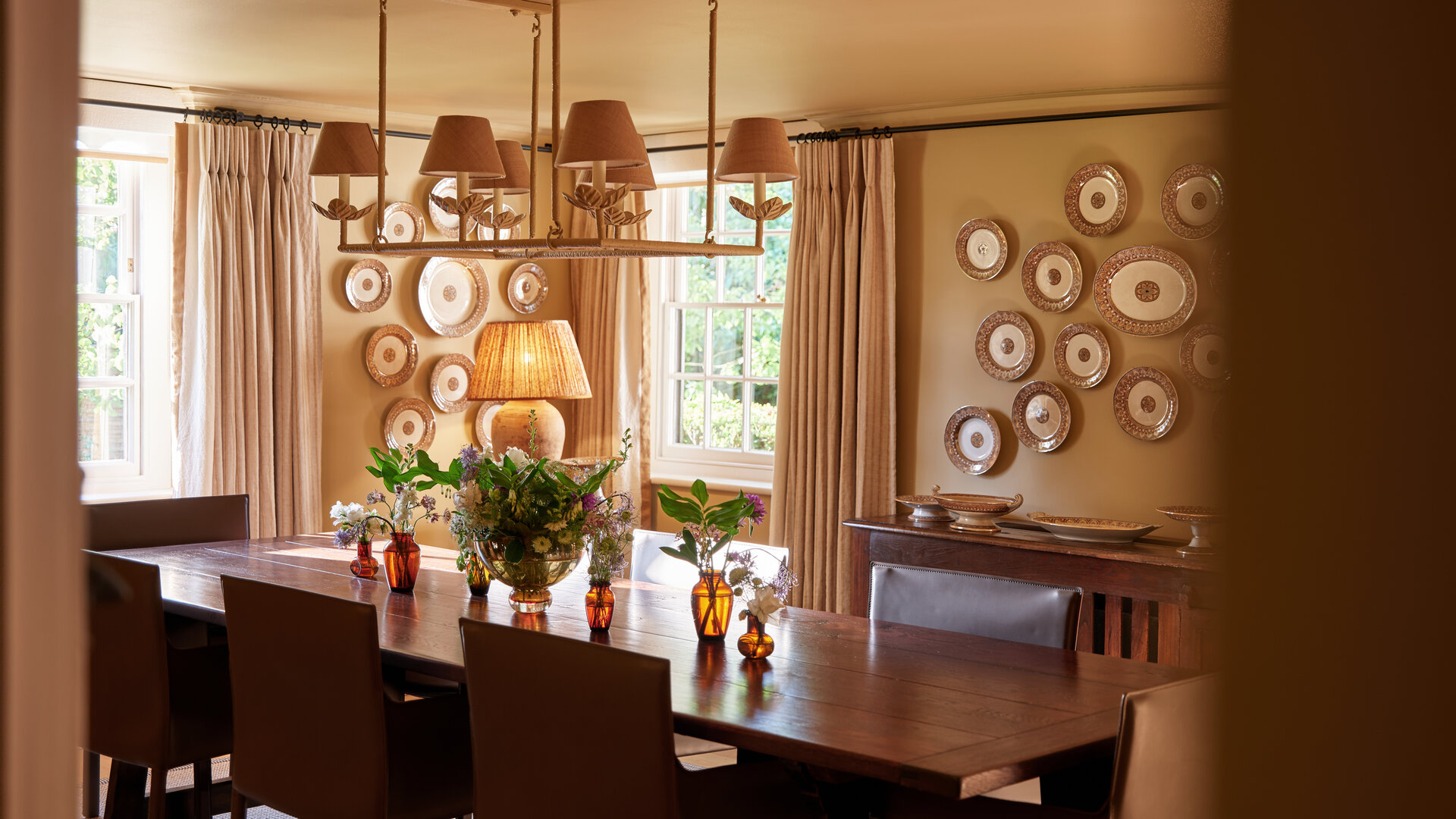Dower House dining room at Coworth Park with warm lighting and decorative plate wall
