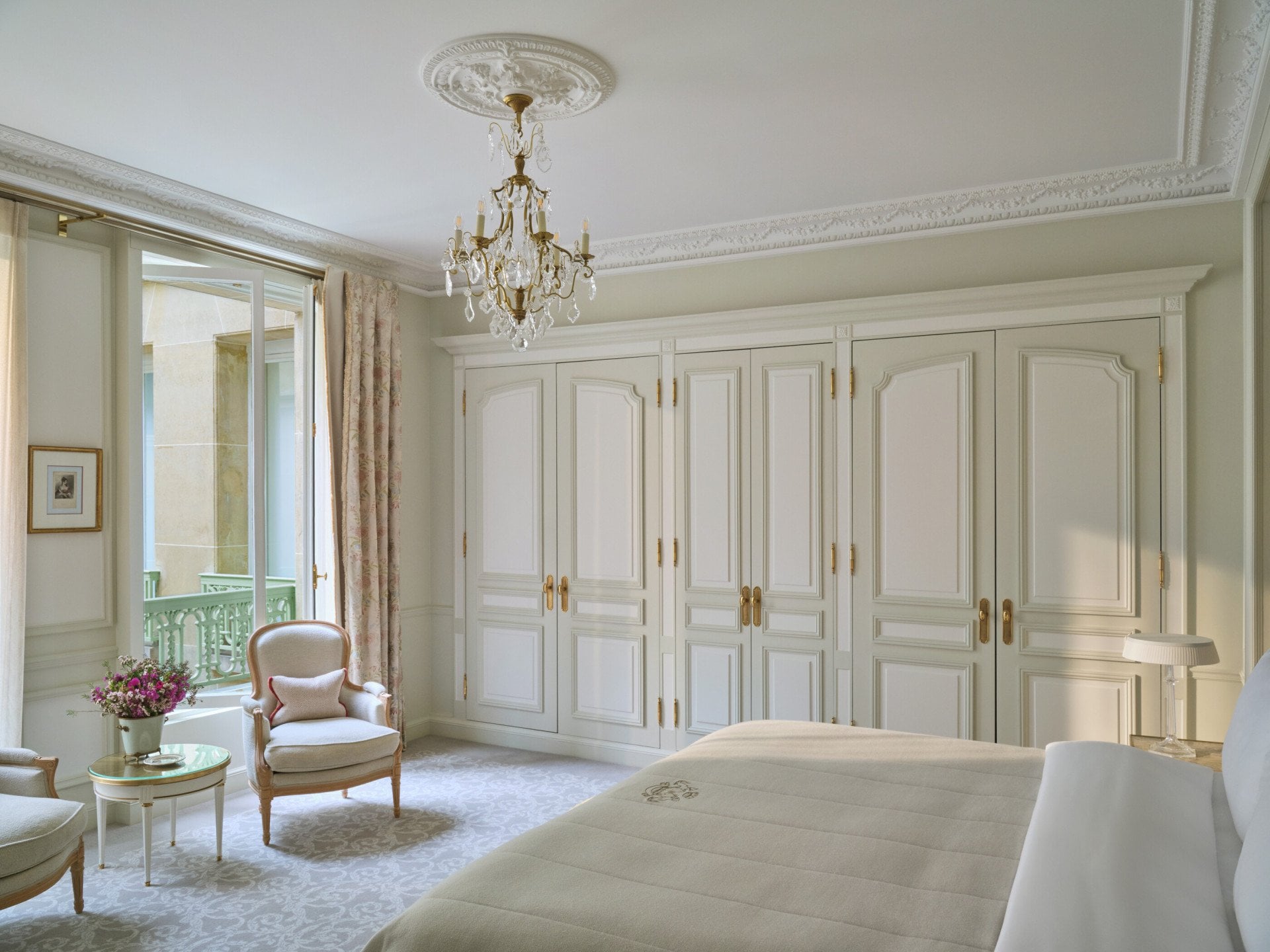 View from the left of an executive room with the bed in front of the chairs and the windows, at Le Meurice, Paris