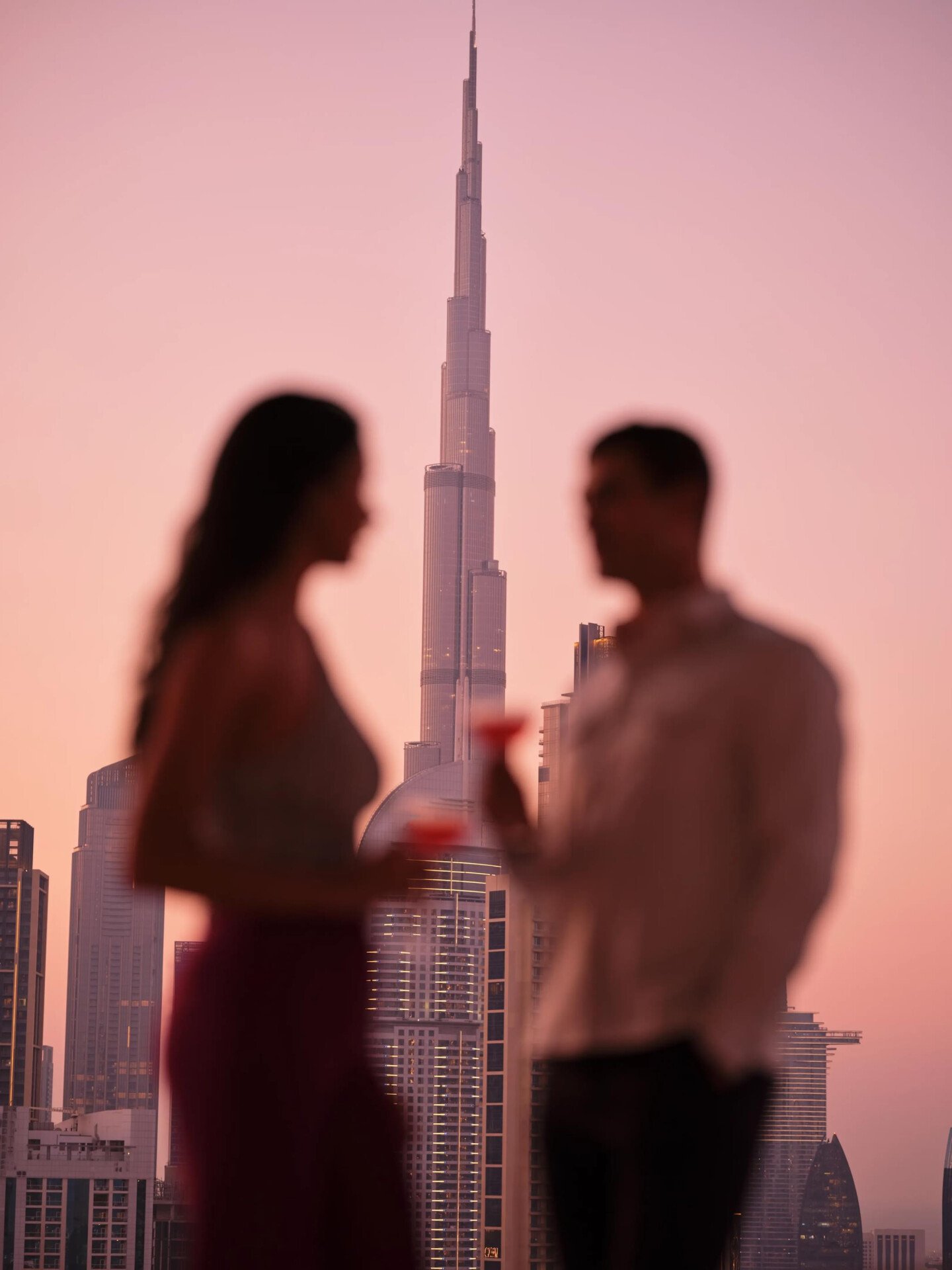 A couple enjoying drinks with the view of Burj Khalifa. 